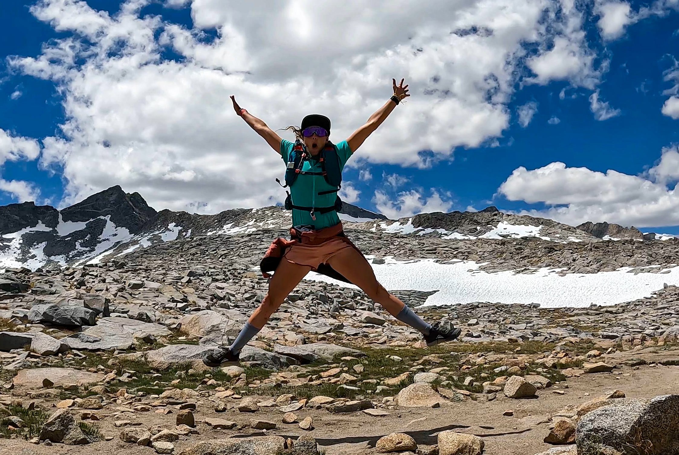 Charlotte Hart - Vespa / OFM Ambassador Jumping spread-eagle in rocky snowy terrain